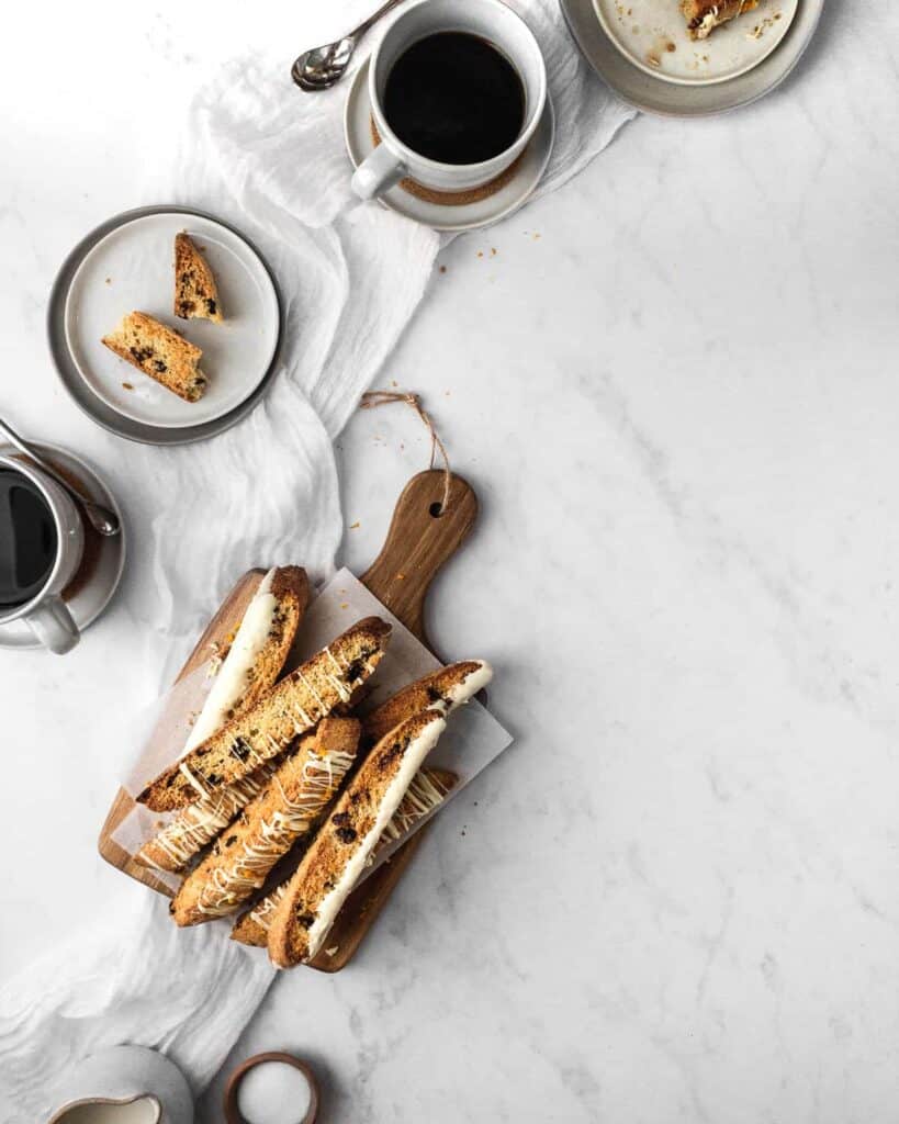 breakfast scene with tray of biscotti and coffee cups