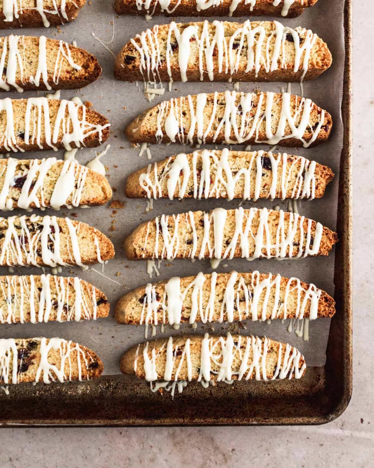 overhead shot of baked biscotti with drizzled white chocolate