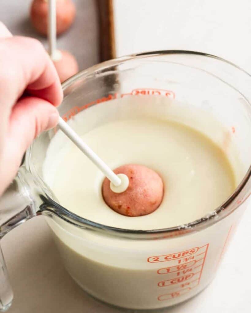 cake pop being submerged into chocolate