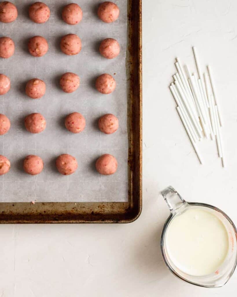 cake balls are ready to turn into cake pops with lollipop sticks