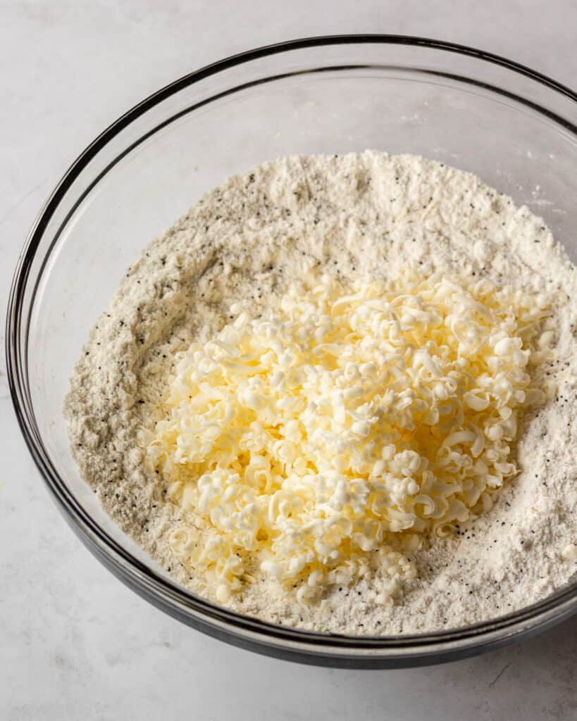 dry ingredients with grated butter dumped in ready to be mixed together.