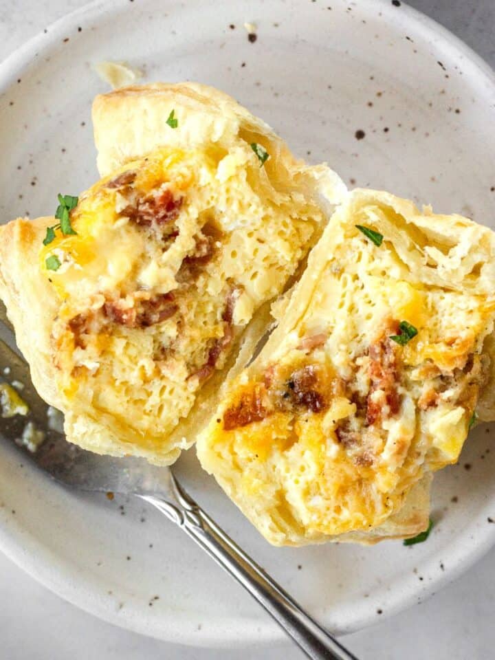 puff pastry breakfast cup cut in half on a white plate