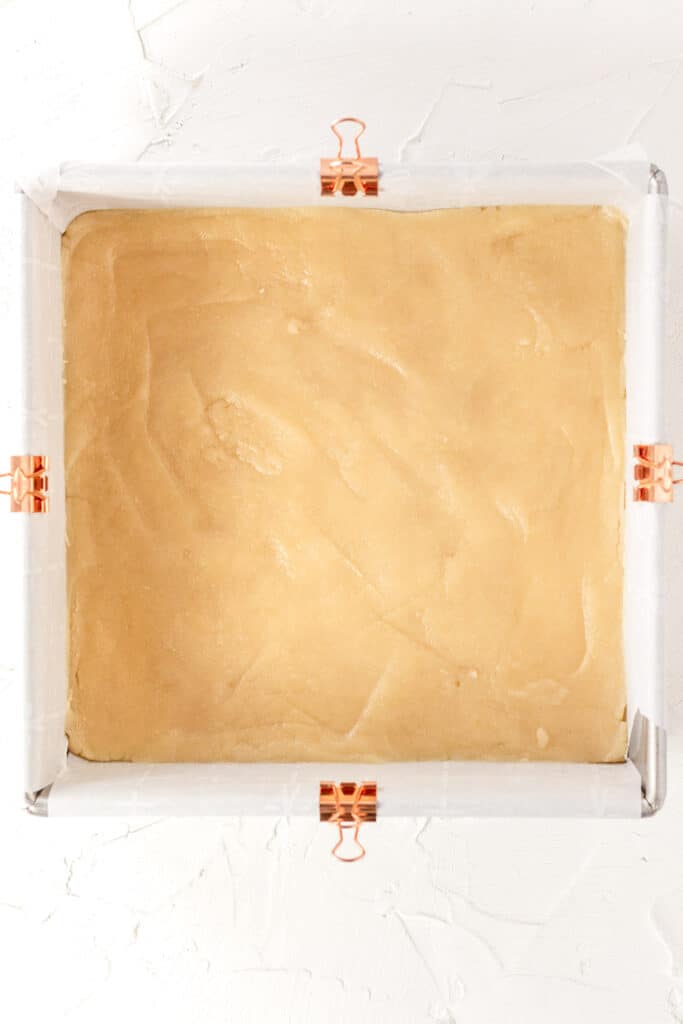 crust dough pressed into the square pan before baking.