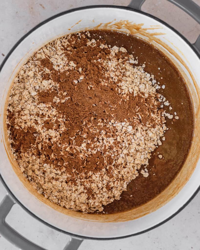 oats and pumpkin pie spice dumped into the pot of liquid mixture.  