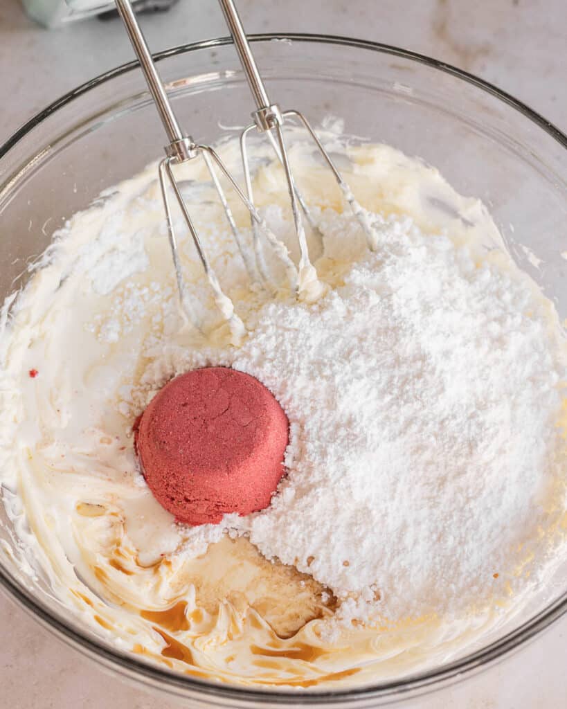butter mixture with powdered sugar, strawberry powder, vanilla, and milk before mixed together