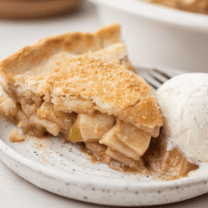 pie sitting on a white plate with a scoop of vanilla ice cream