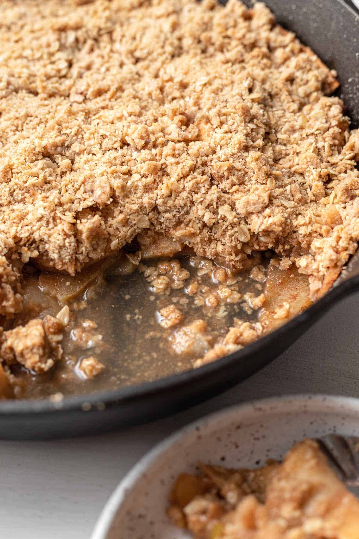 scooped out apple crisp in the cast iron skillet 