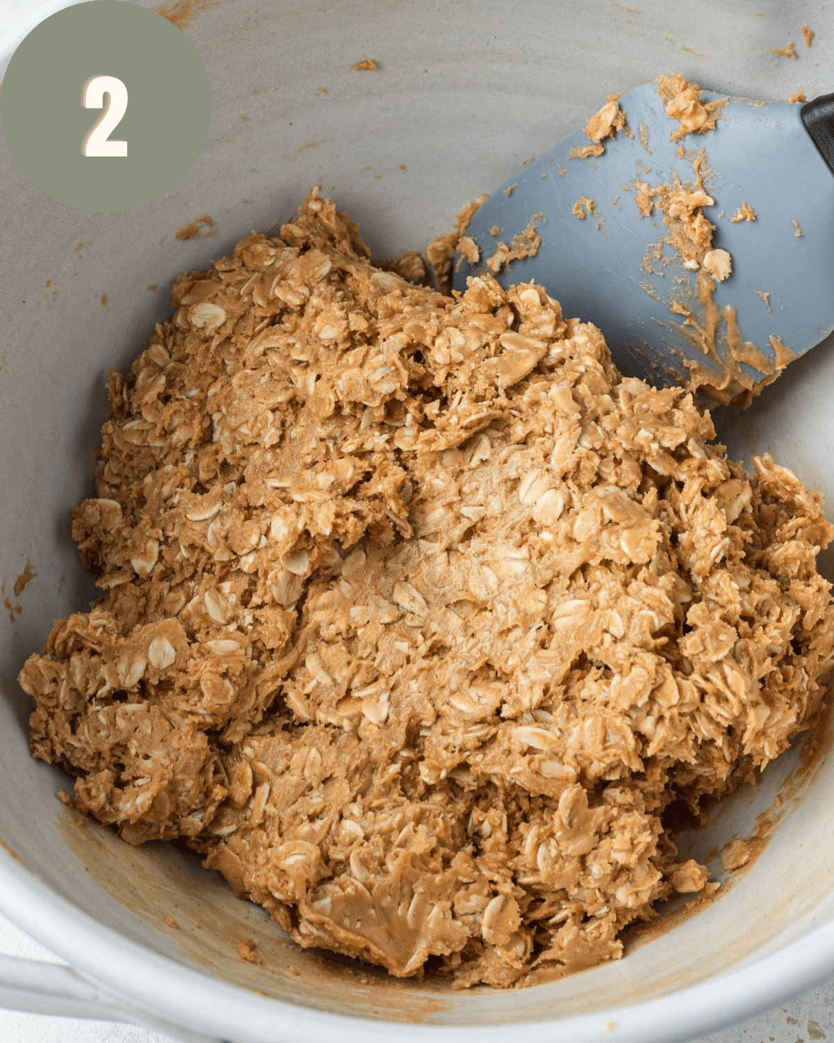 oat mixture fully mixed in a bowl with a rubber spatula