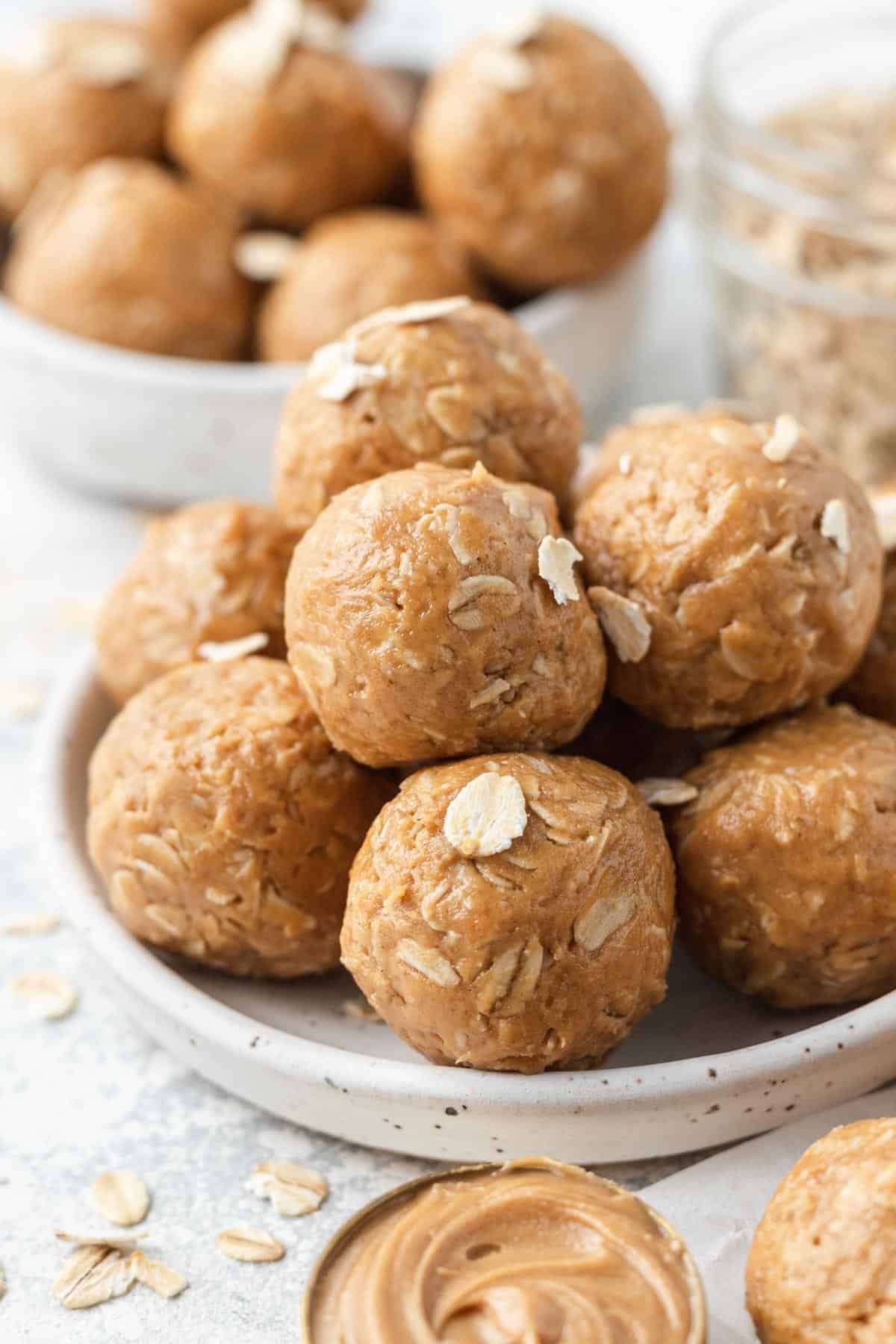 peanut butter balls stacked together on a white plate 