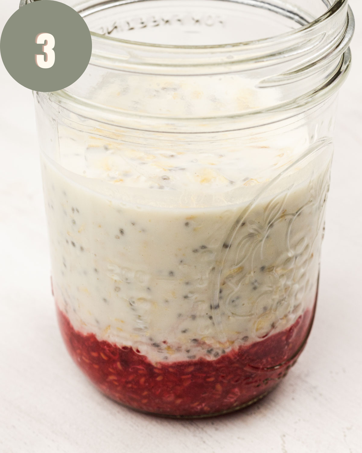 raspberries and oats together in a clear mason jar before sitting overnight