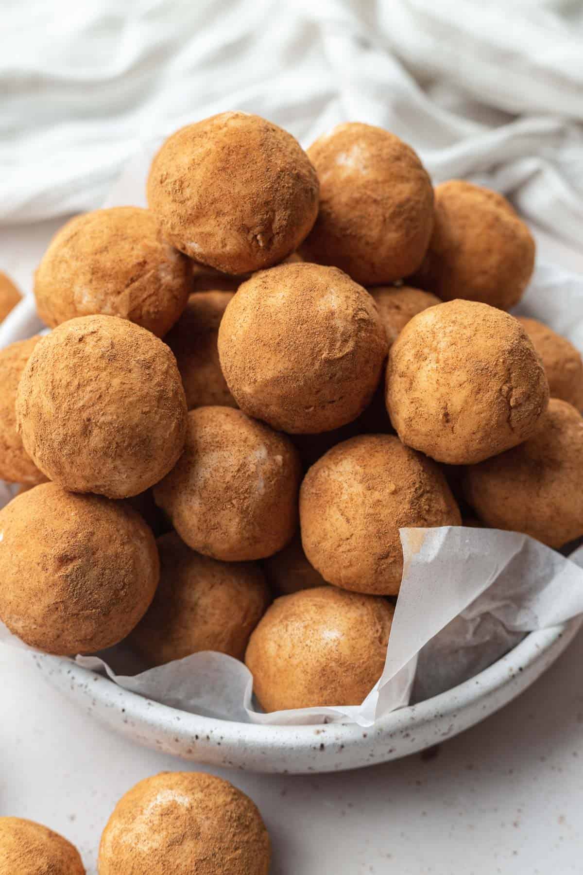 a large pile of Irish potatoes stacked in a white bowl