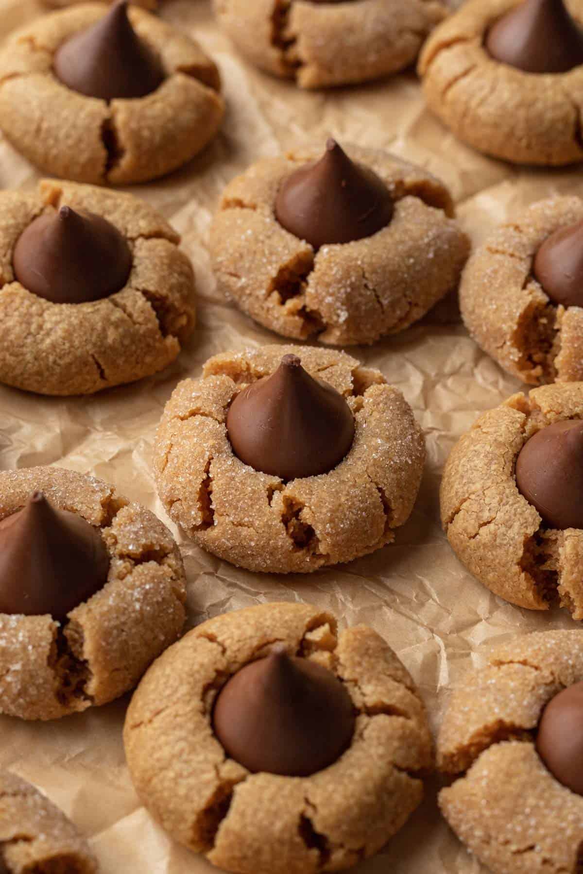 Peanut Butter Blossoms on baking sheet that is lined with parchment paper.