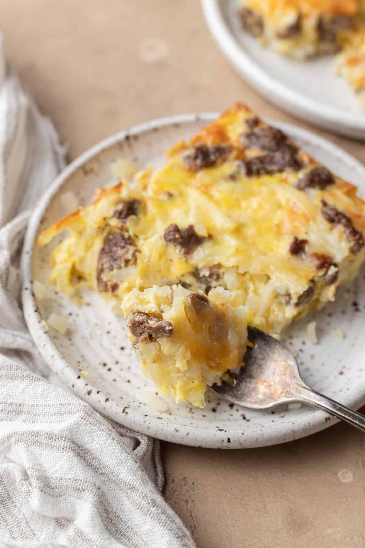 Slice of Dairy-Free Breakfast Casserole that is resting on a plate and ready to be eaten.