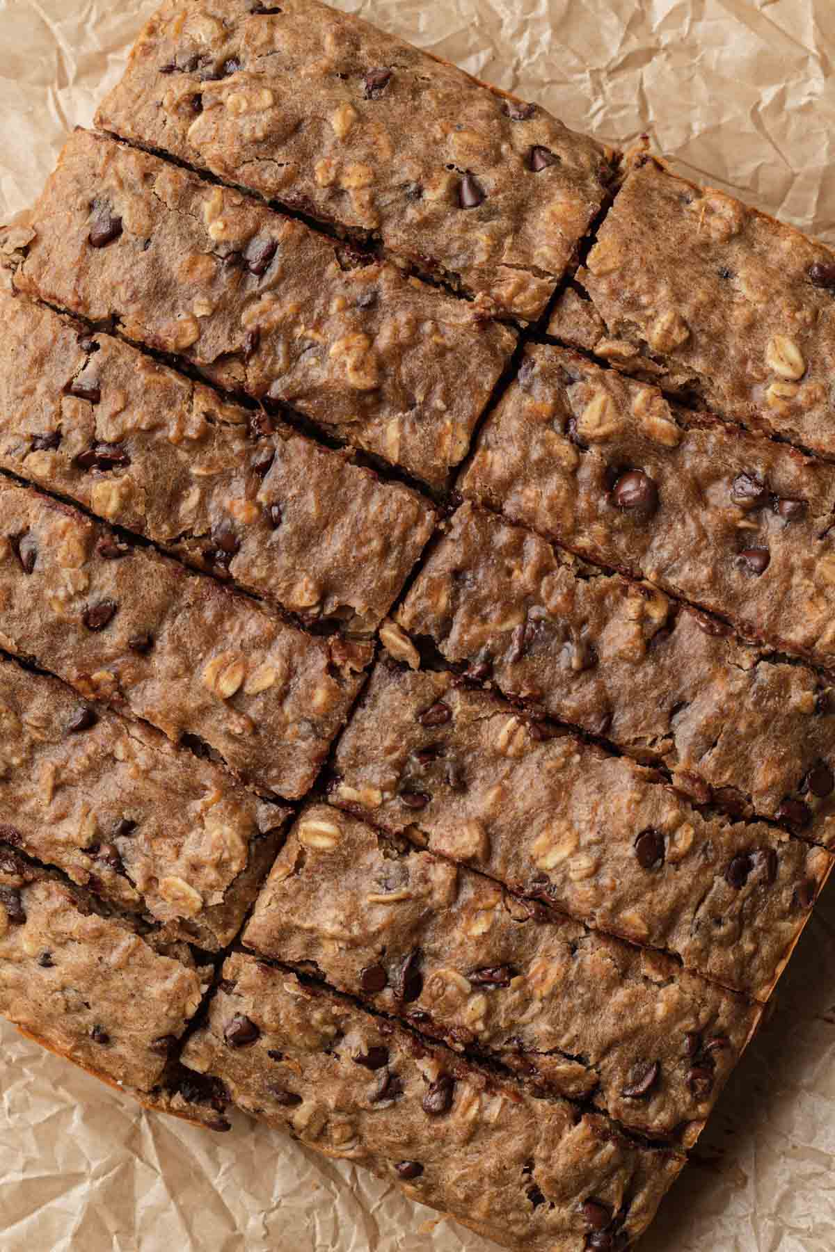 Freshly baked peanut butter oatmeal banana bars cut into rectangles and ready to serve.