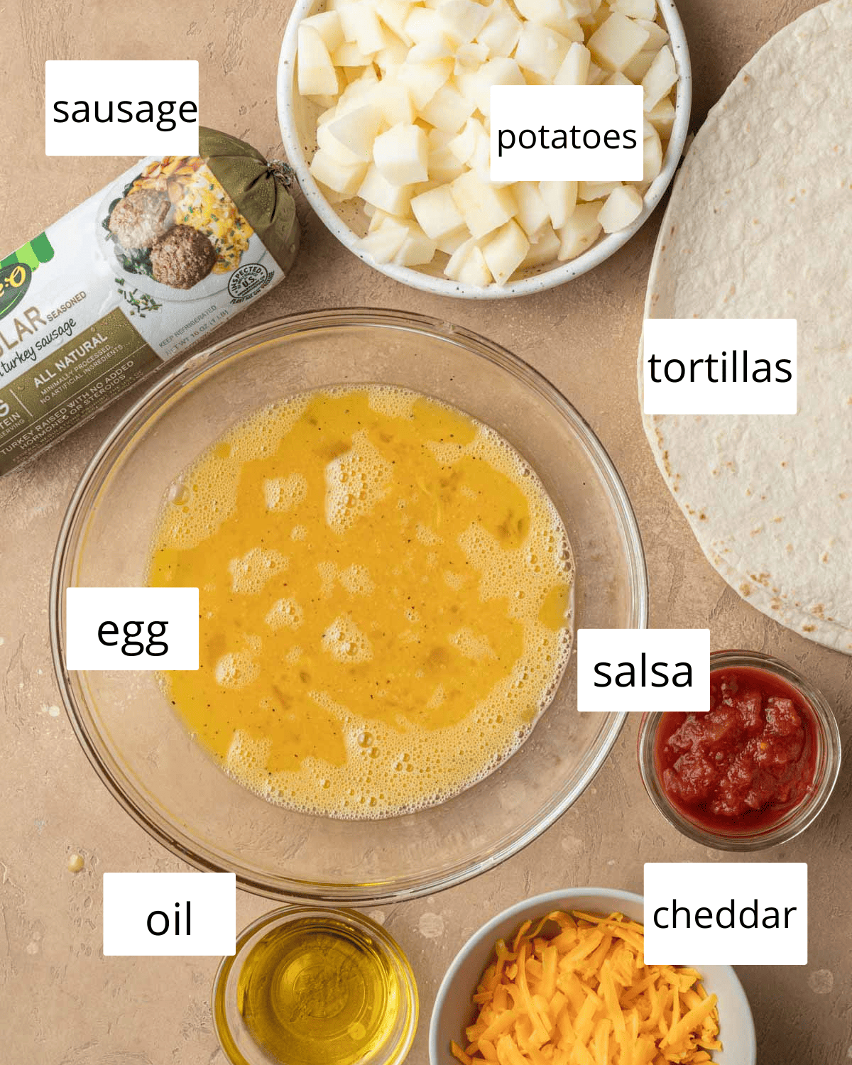 ingredients needed to make potato breakfast burritos laid out on a brown backdrop.