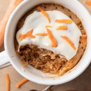 Freshly made carrot cake mug cake that is ready to be eaten.