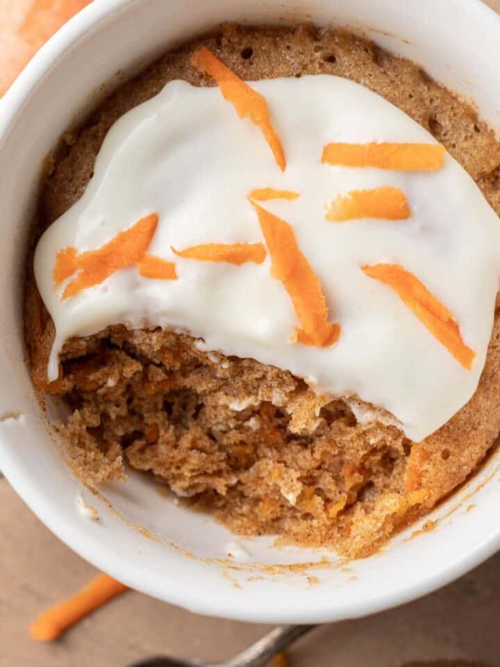 Freshly made carrot cake mug cake that is ready to be eaten.