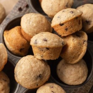 mini chocolate chip muffins stacked on top of one another in a muffin tin