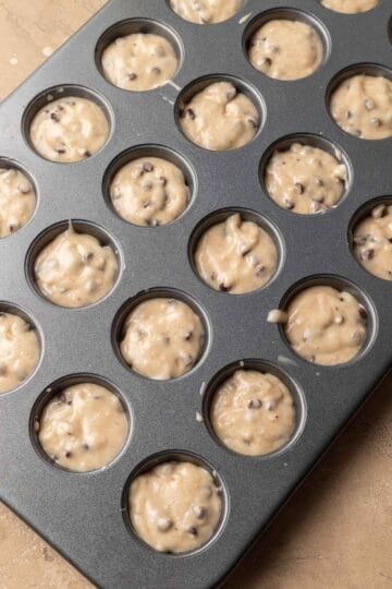 muffin batter in mini muffin tin ready to be baked.