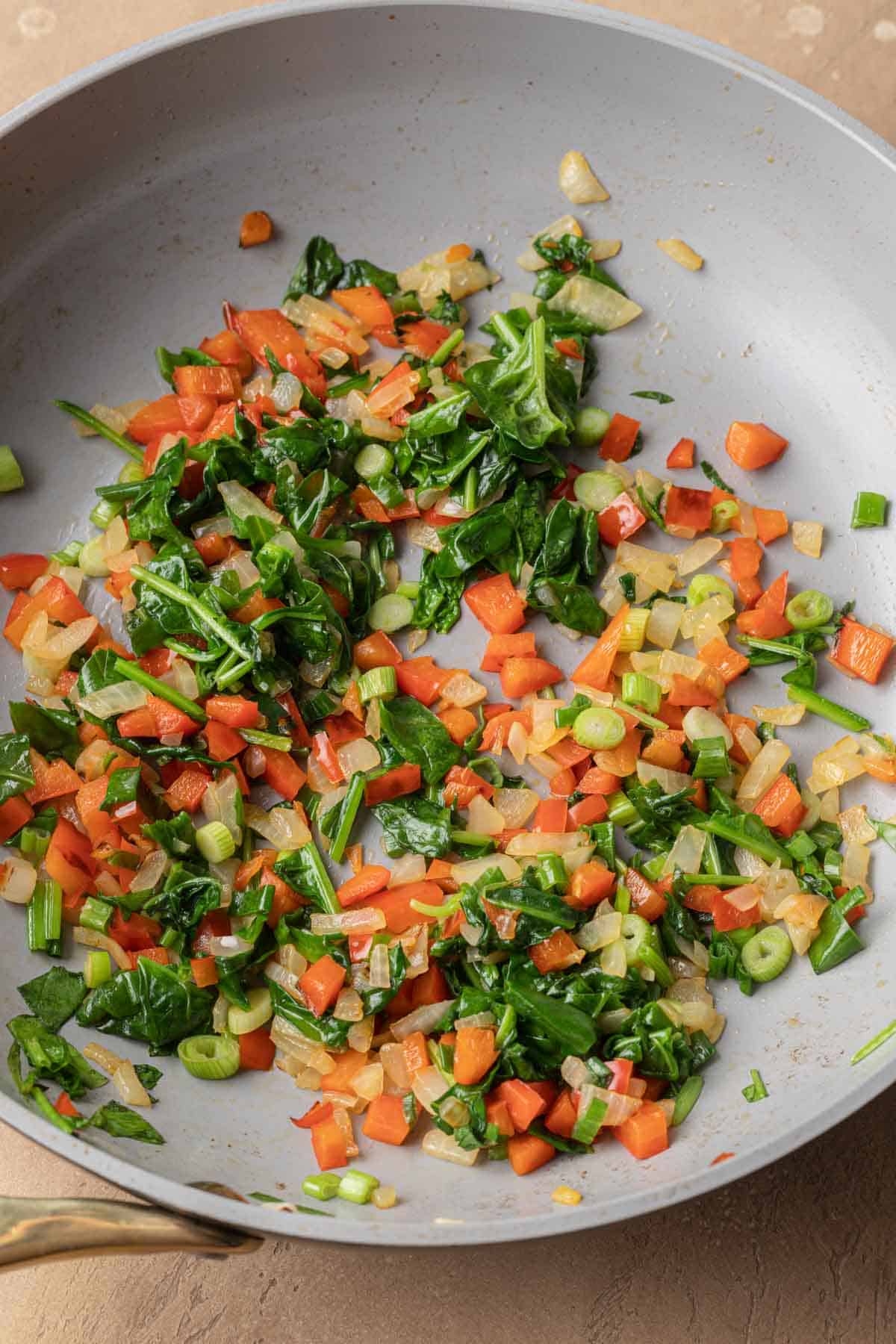Sautéed vegetables in a frying pan.