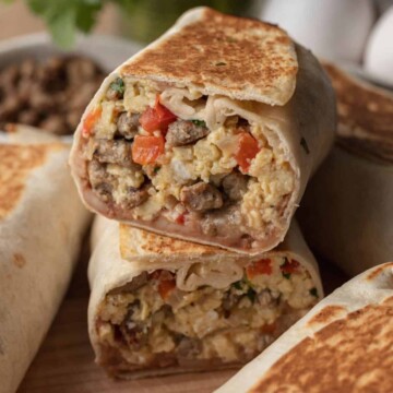two halves of breakfast burrito stacked on top of one another