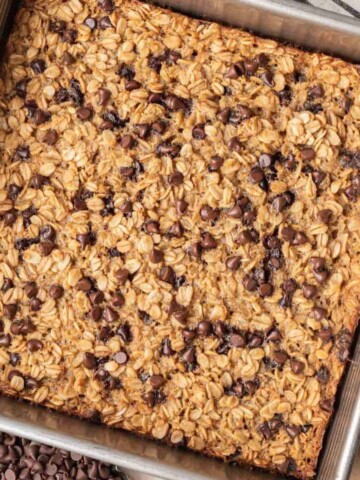 Chocolate chip baked oatmeal freshly baked sitting in a tin baking sheet.