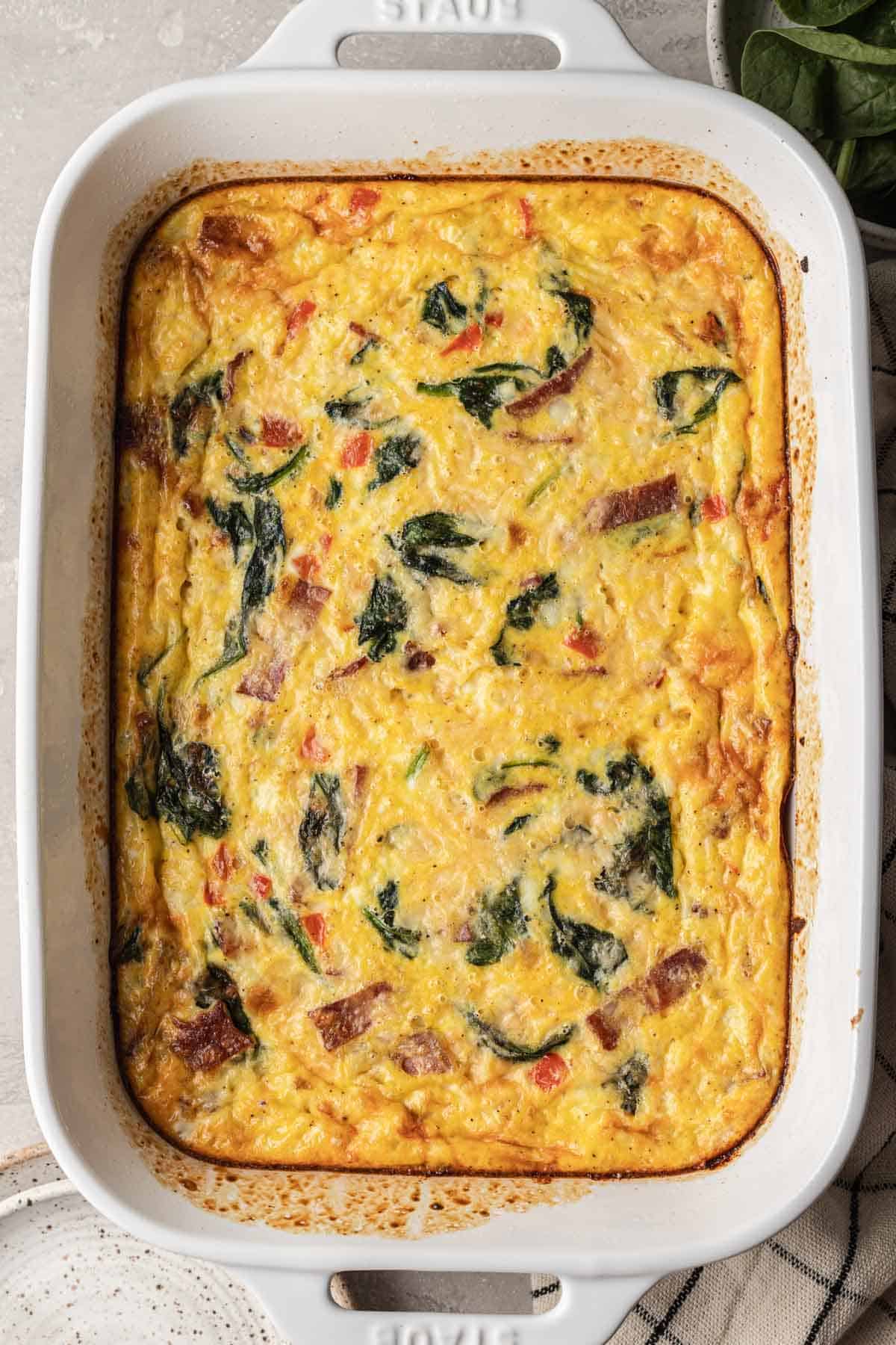 overhead shot of baked cottage cheese egg bake in a white casserole dish.