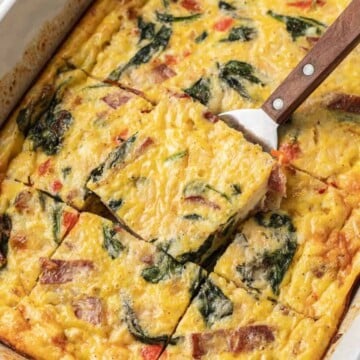 slice of egg bake being lifted out of pan by spatula.