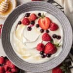 bowl of blended cottage cheese topped with berries and honey