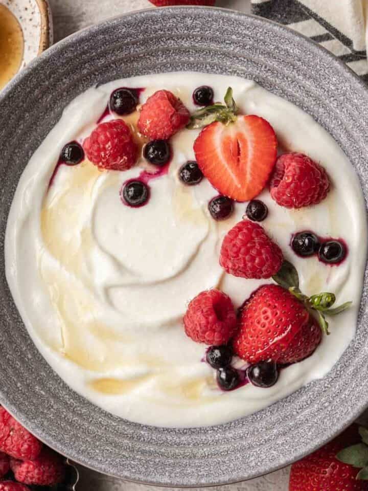 bowl of blended cottage cheese topped with berries and honey