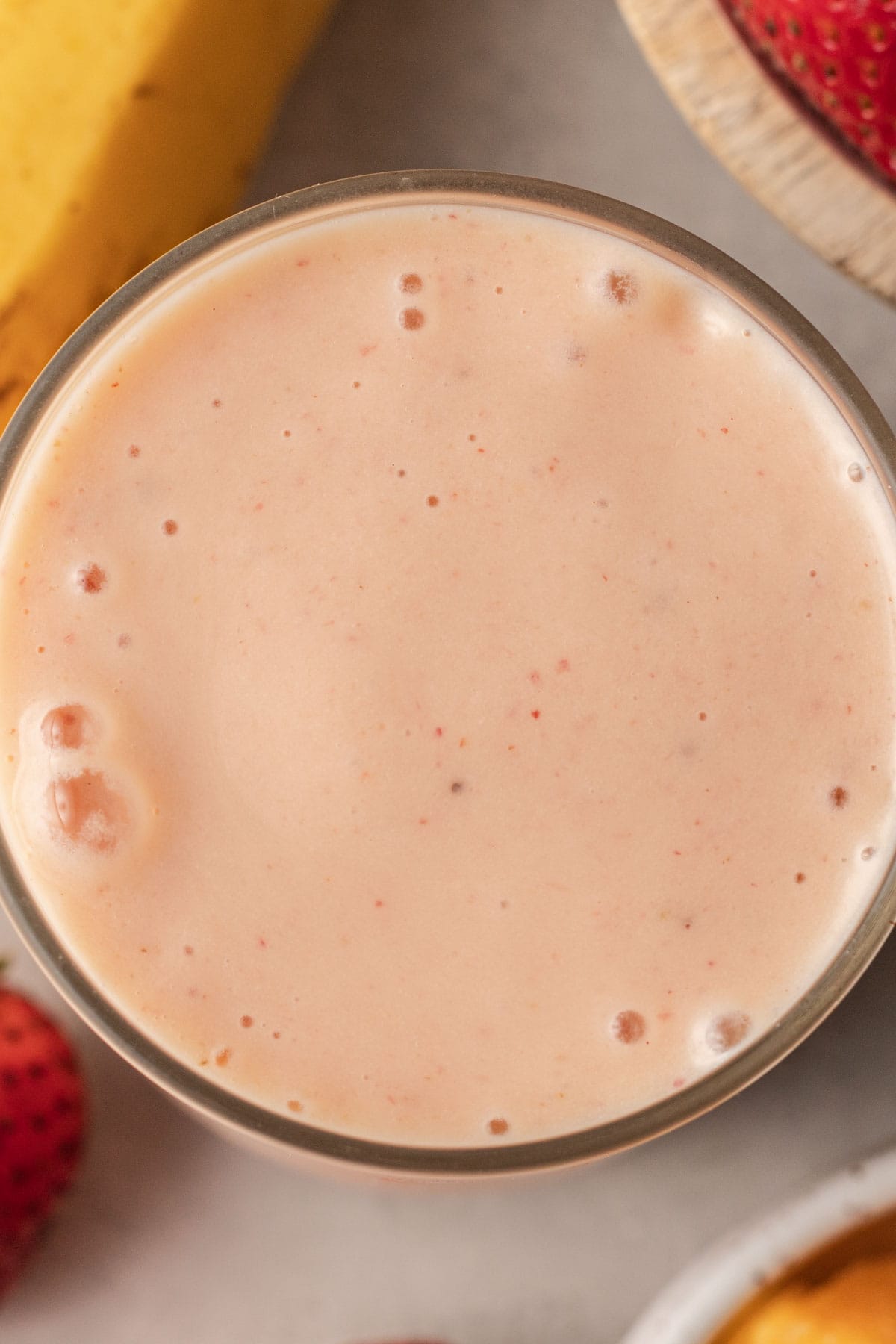 Birds eye view of mango strawberry banana smoothie.
