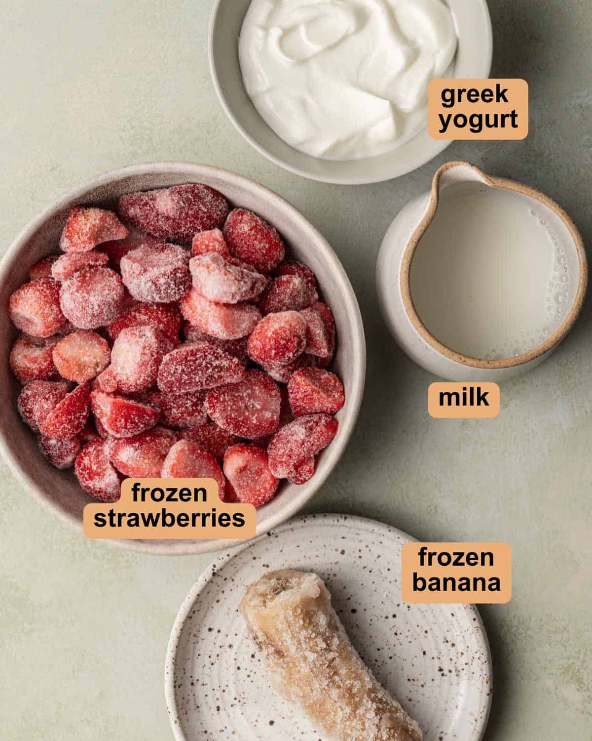 Ingredients to make strawberry smoothie bowl.