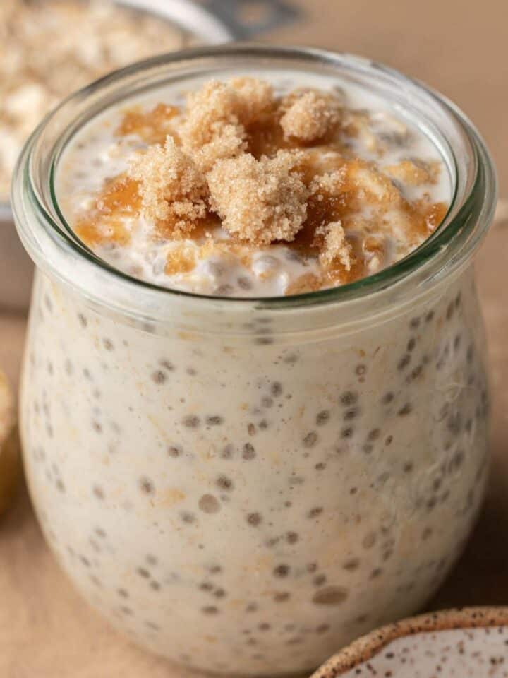 brown sugar overnight oats in a glass jar topped with extra brown sugar.