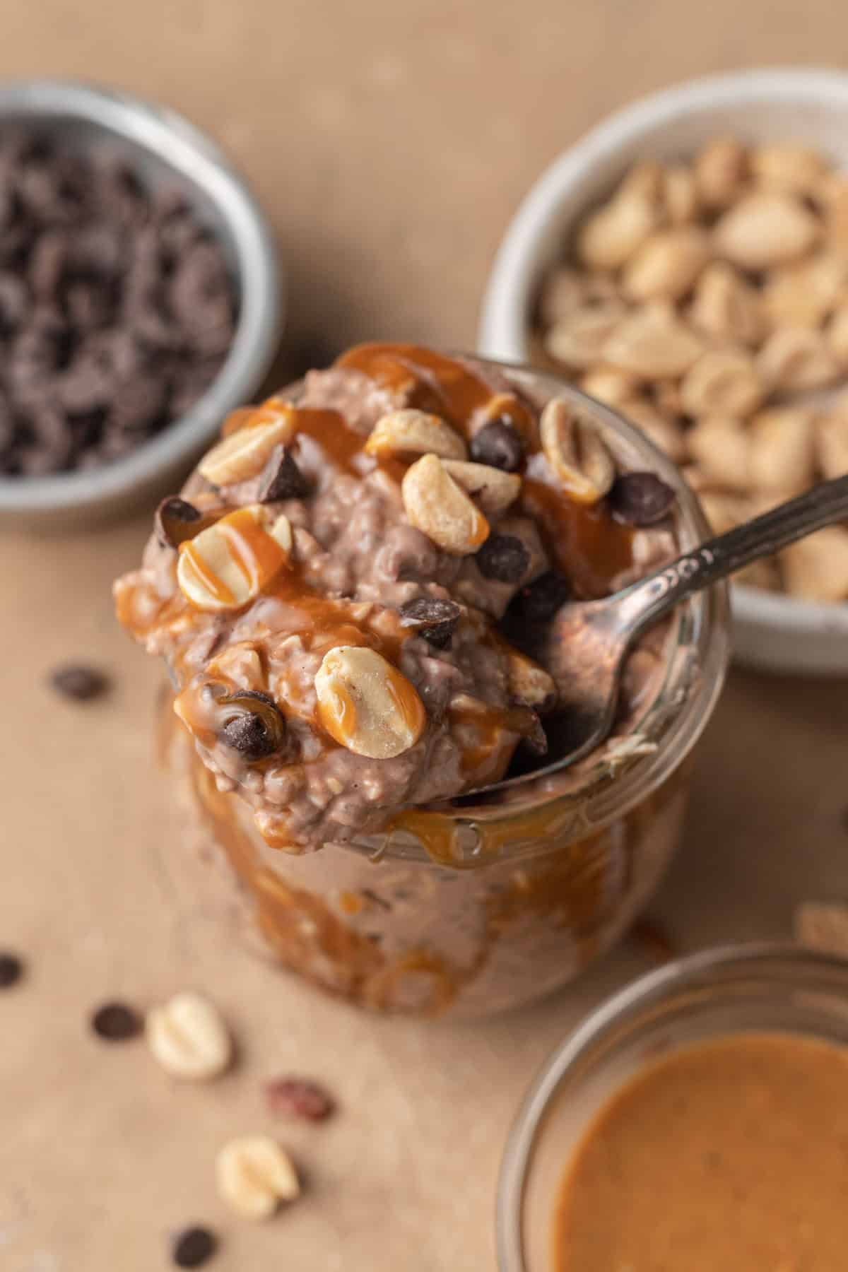 spoonful being taken out of snickers overnight oats.