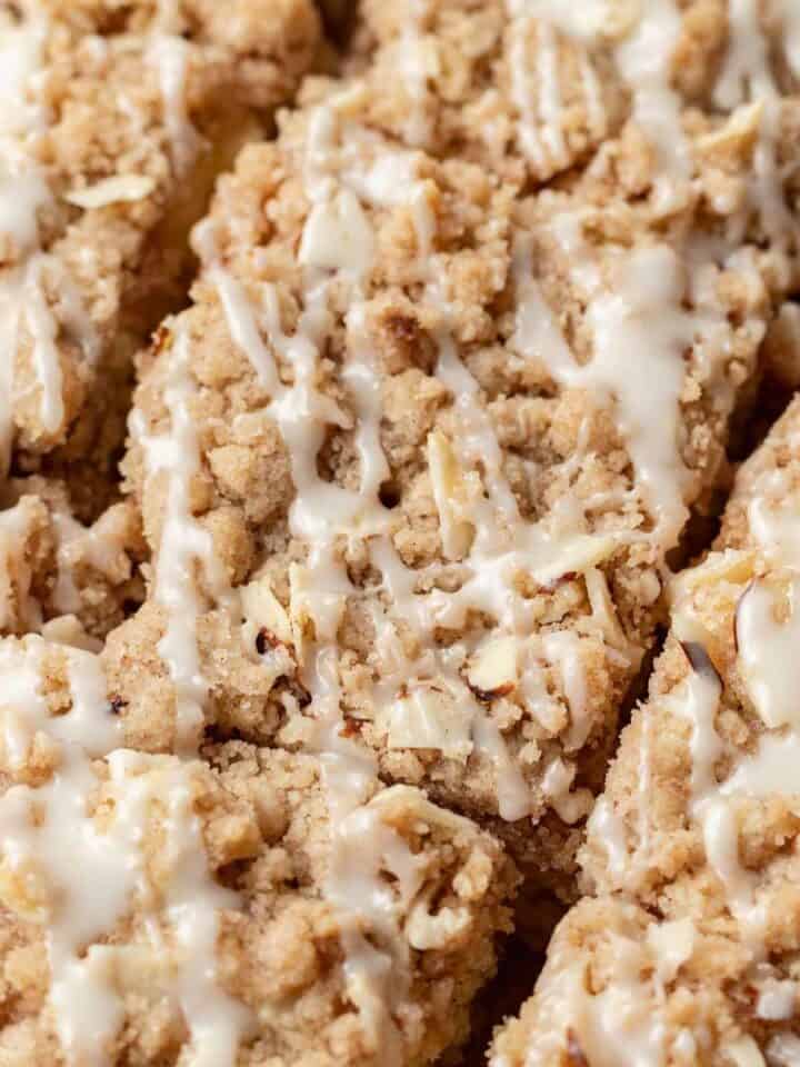 slices of almond coffee cake with icing drizzled on top.