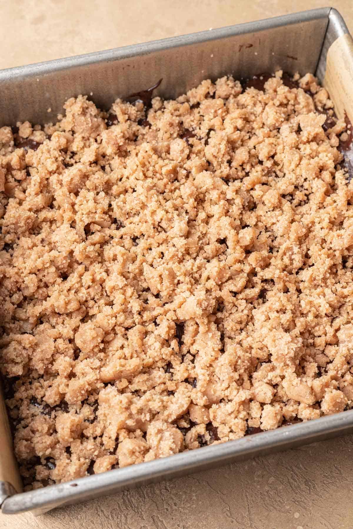streusel topping on cake batter in a square pan