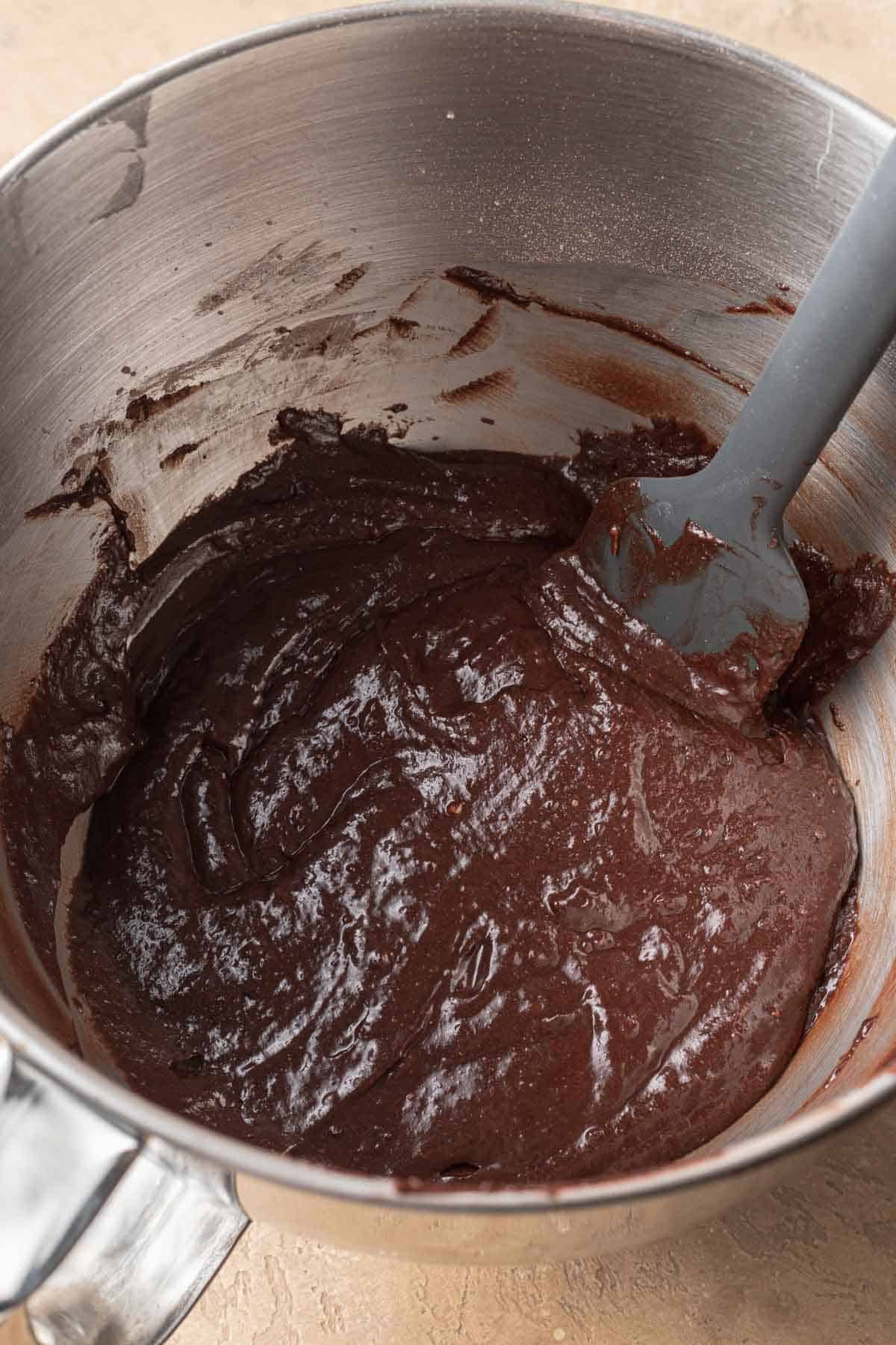 chocolate coffee cake batter in a silver mixing bowl.