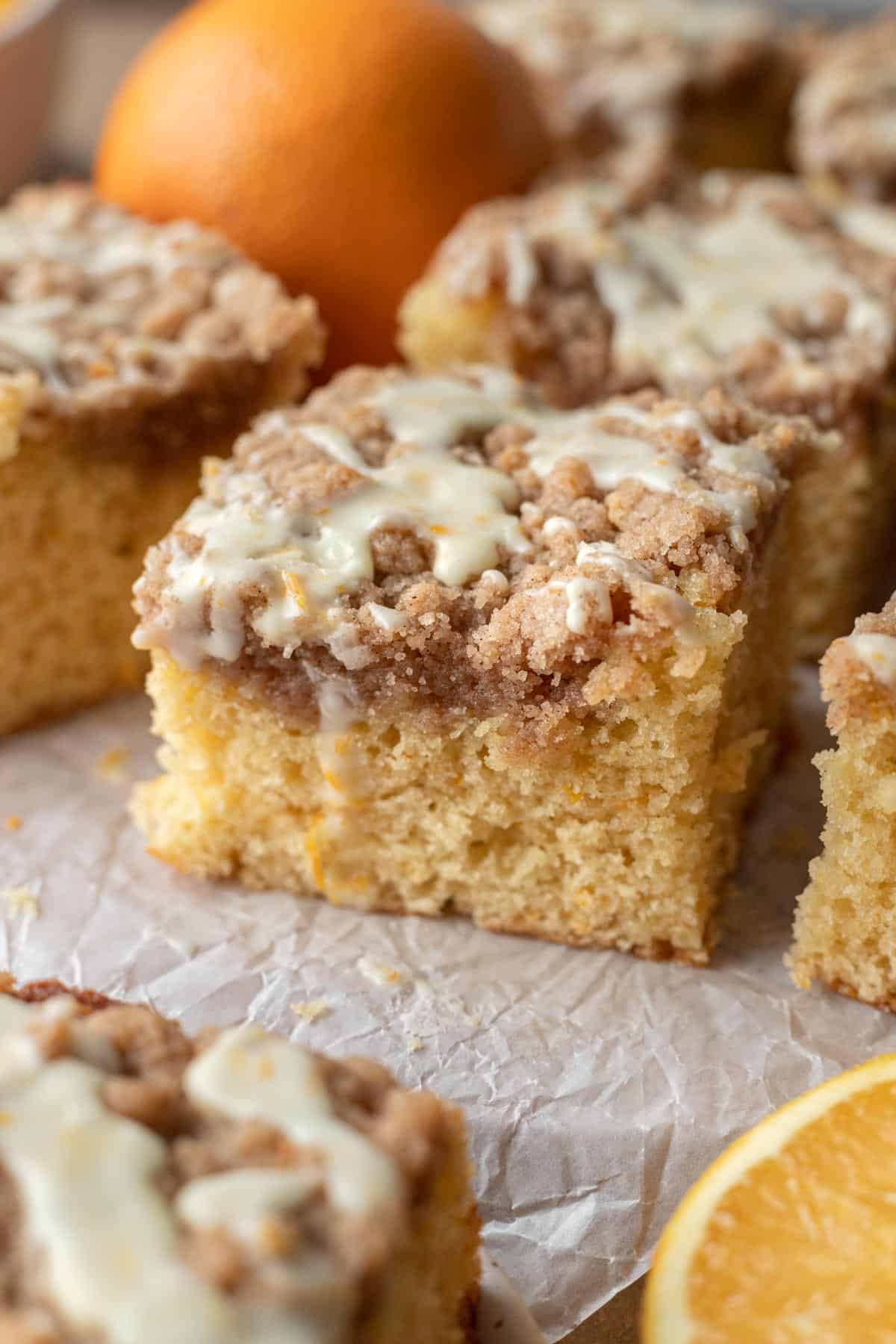 slice of orange coffee cake on parchment paper.