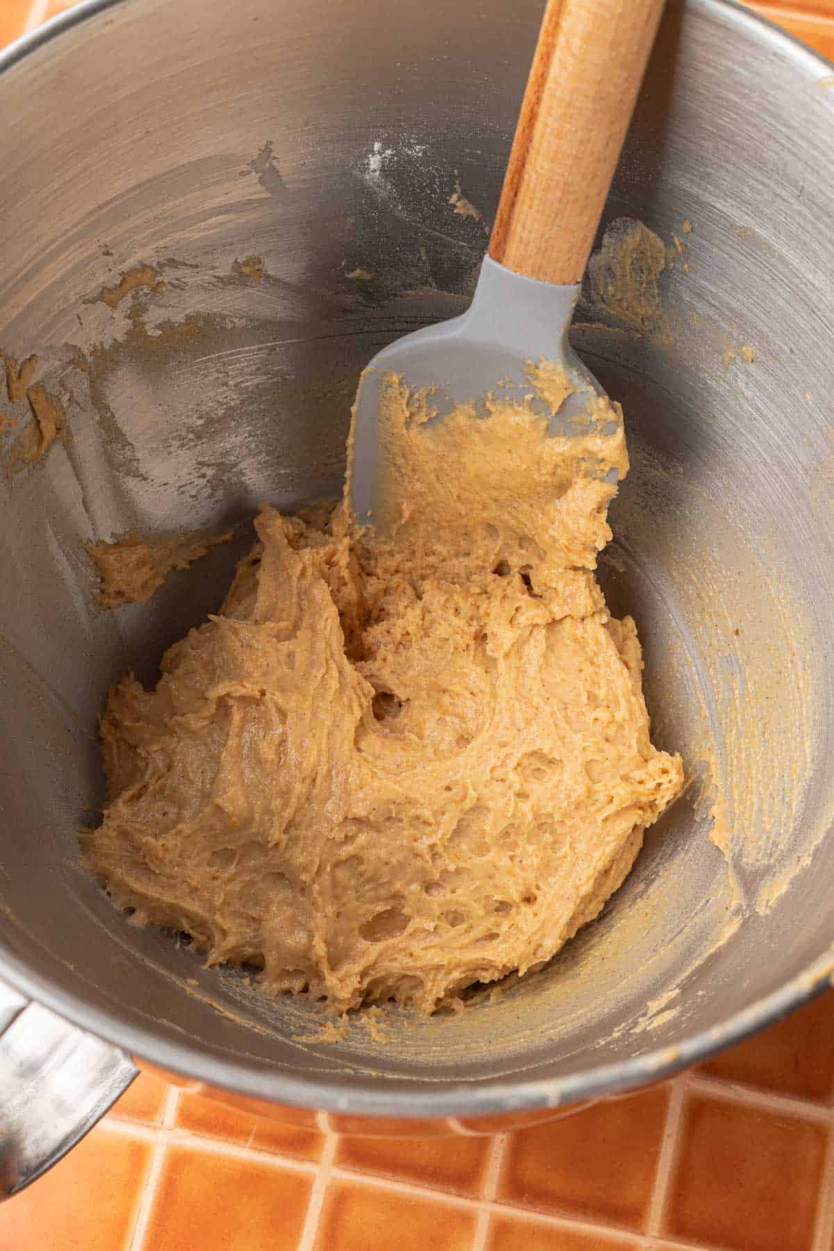 pumpkin coffee cake batter mixed together in a stainless steel mixing bowl.