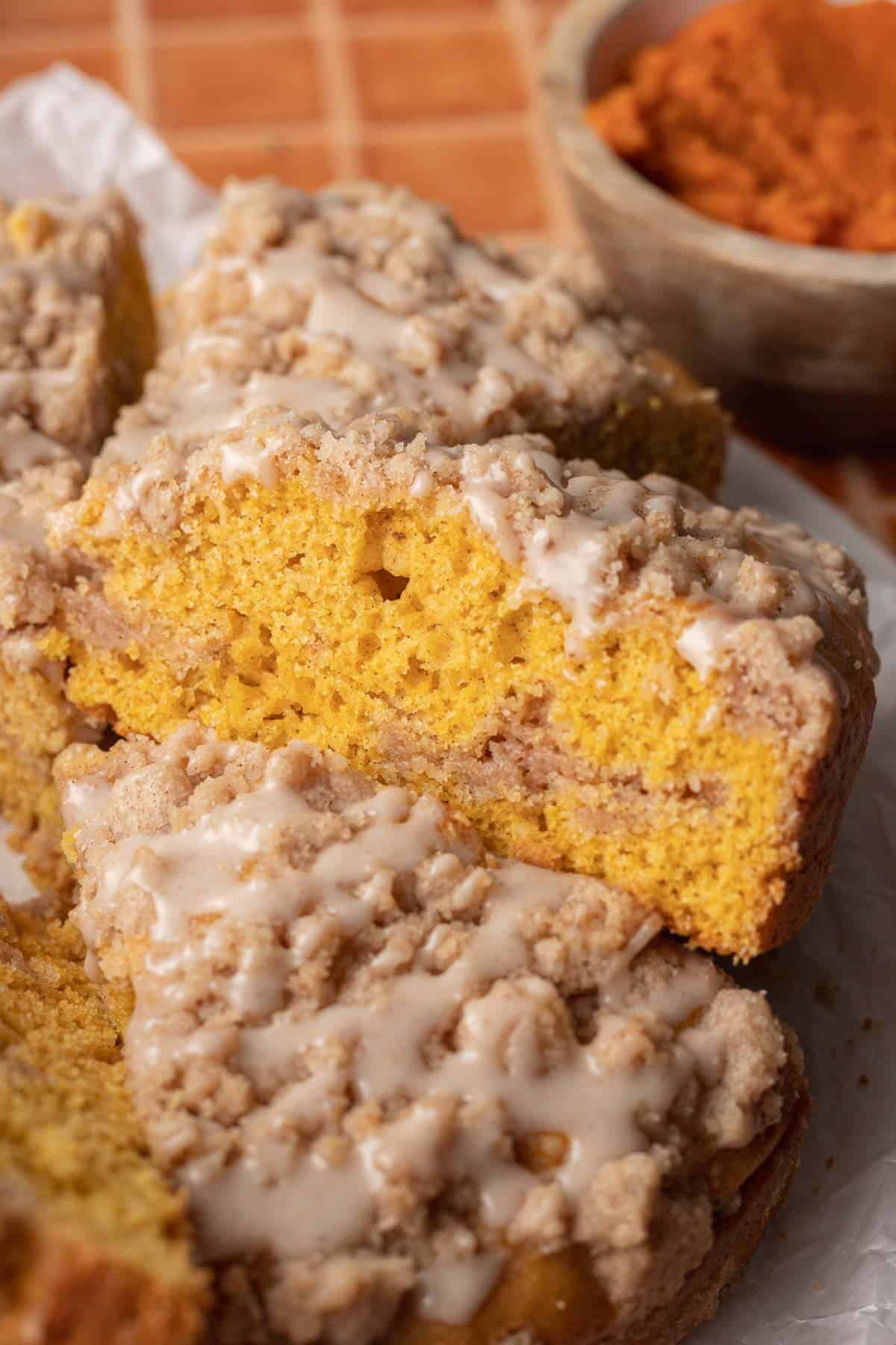 up close shot of side of pumpkin coffee cake where you can see the layers of streusel.