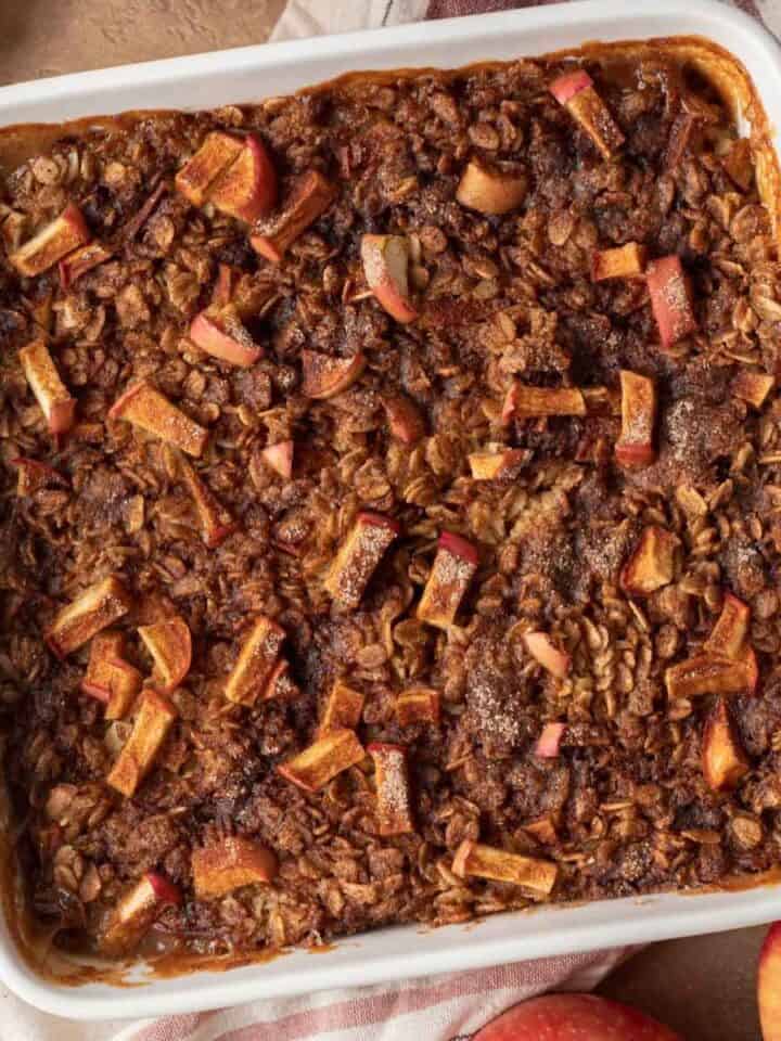 overhead view of apple baked oats in a white square baking dish.