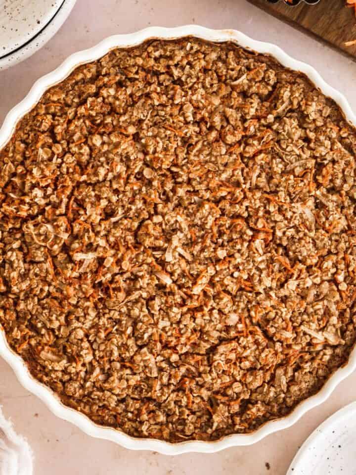 overhead shot of carrot cake baked oatmeal in a round white dish