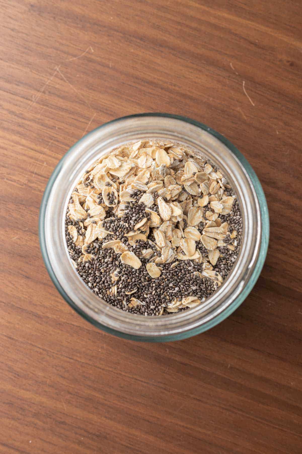 oats and chia seeds mixed together in a glass jar.