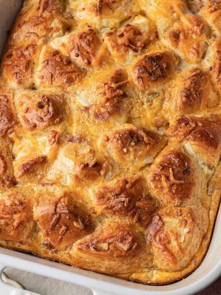 Golden-brown baked casserole with a flaky, biscuit top in a white rectangular dish.