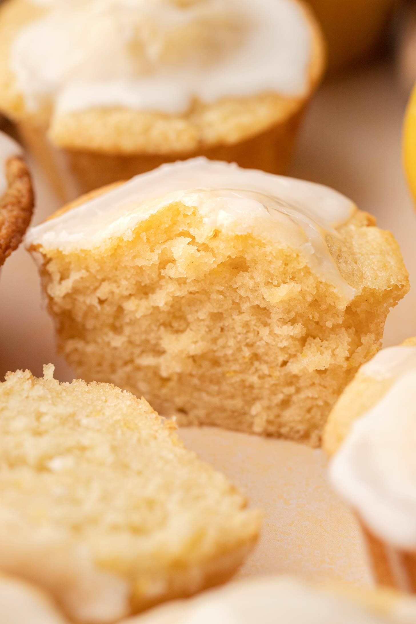 A close-up of a glazed muffin cut in half, showing its moist and fluffy texture.